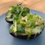 Avocado baked eggs with Brussel sprout salad