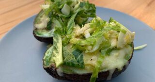 Avocado baked eggs with Brussel sprout salad