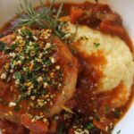 Creamy polenta topped with turnip osso bucco and pistachio gremolata